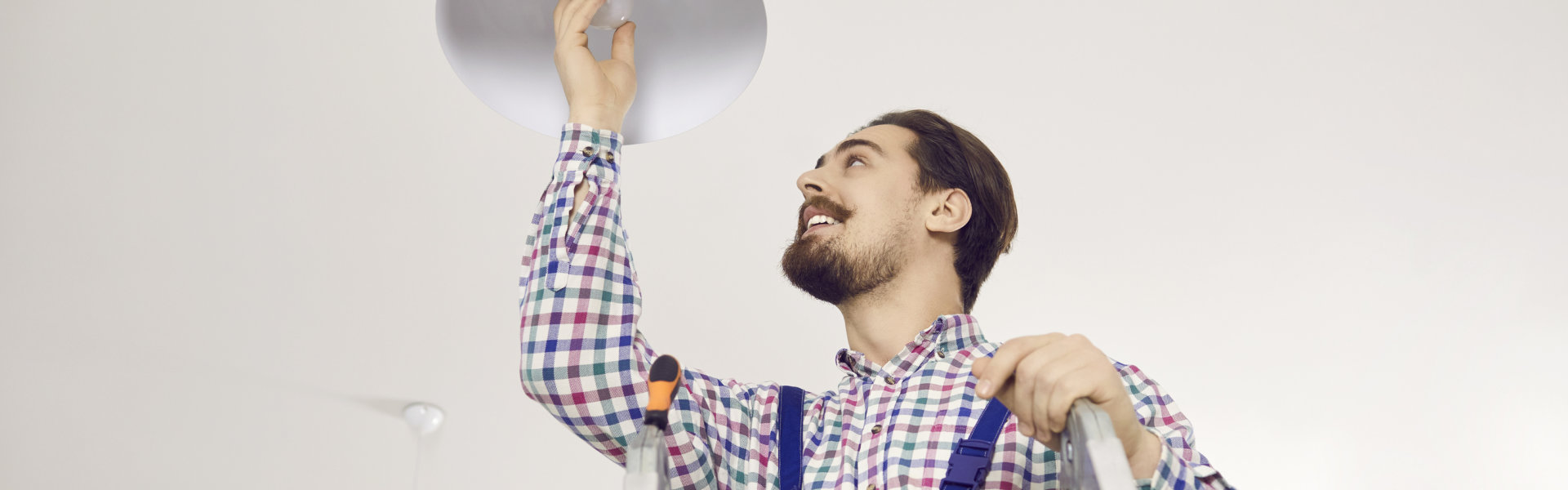 janitor changing light bulb